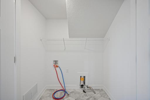 *Photo of model home, actual features may vary. The laundry room.