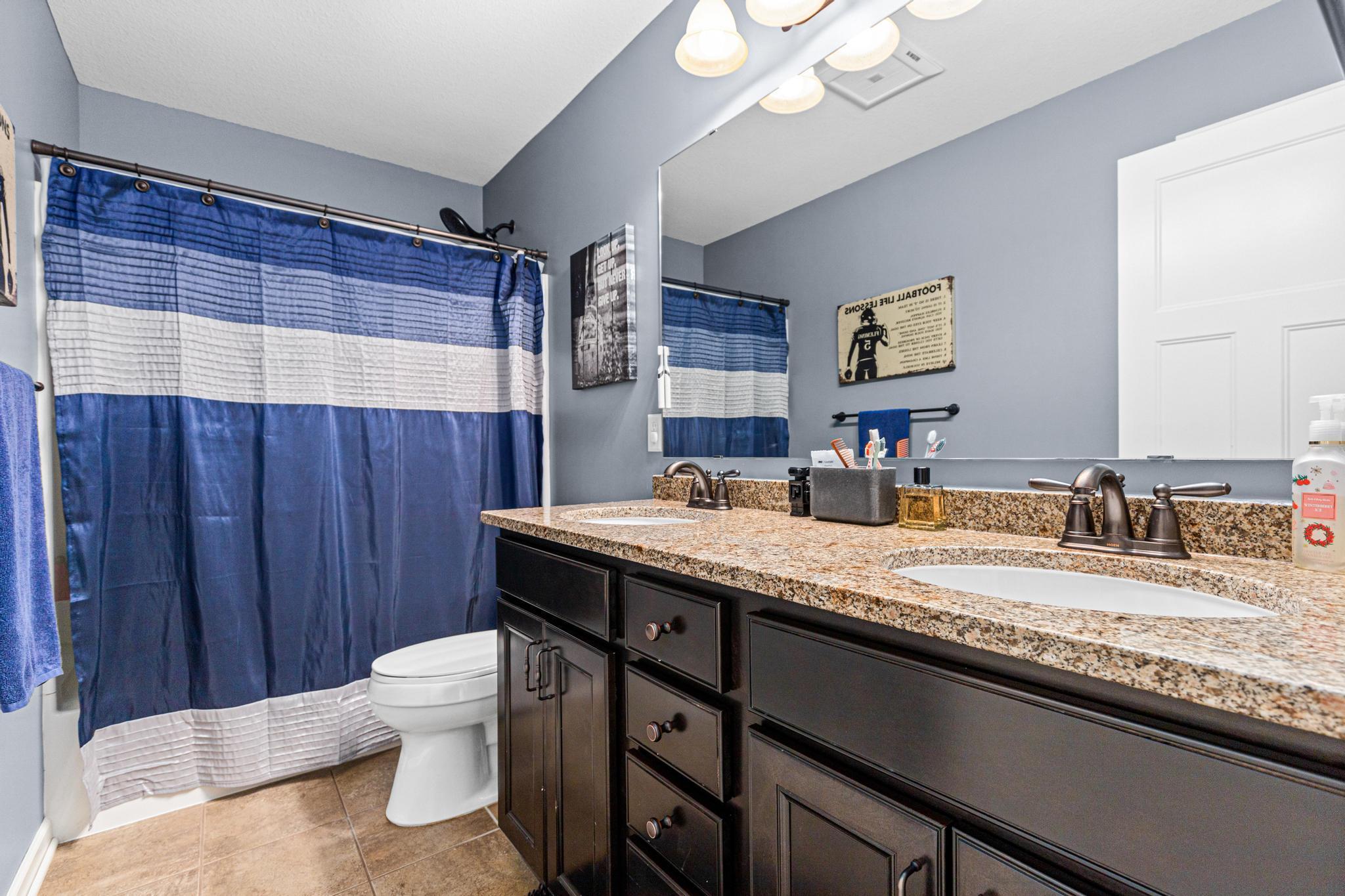 Upper level full bath with dual vanity.