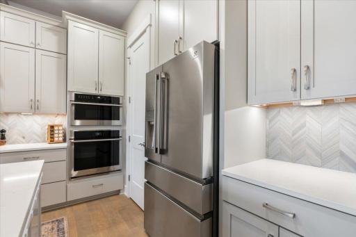 Tons of countertop space and cabinets with a oversized pantry which includes custom shelving