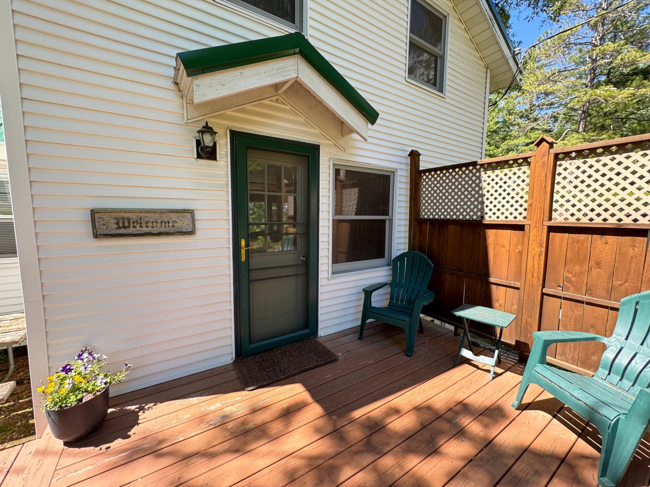 Wood deck for relaxing away from the waters edge. This entrance brings you into the kitchen when you enter.