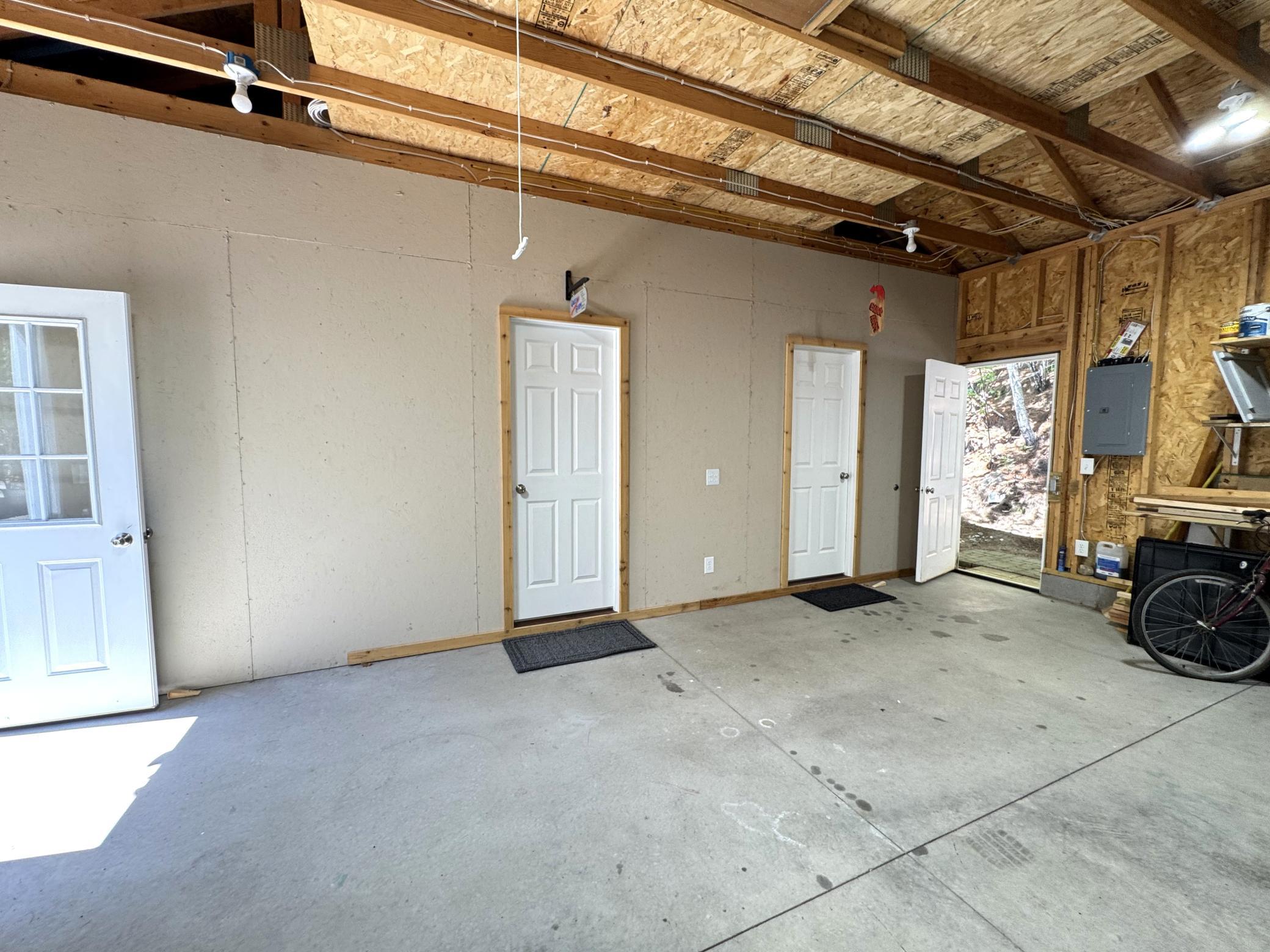 View of the inside of the garage showing the doors to the two guest rooms,