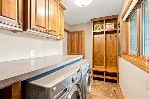 Laundry room with built in bench and storage