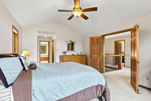 Primary bedroom that shows hall that leads to walk in closet and large primary bathroom