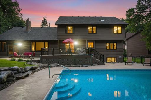 Twilight view of the back of the house and pool