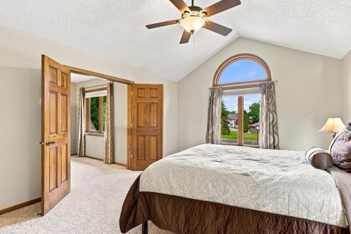 Primary bedroom with double doors for a grand entrance and large window for natural light