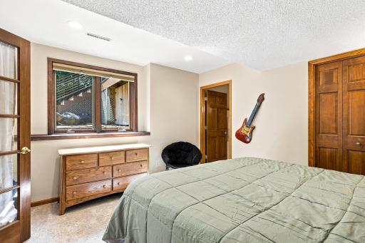 Lower level bedroom with door to private bathroom