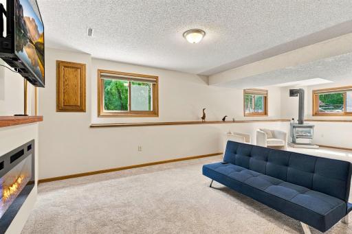 Recreation room with windows for natural light to come in in the lower level