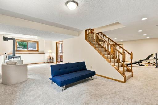Lower level with recreation room with view of the exercise room and door leading to the bedroom
