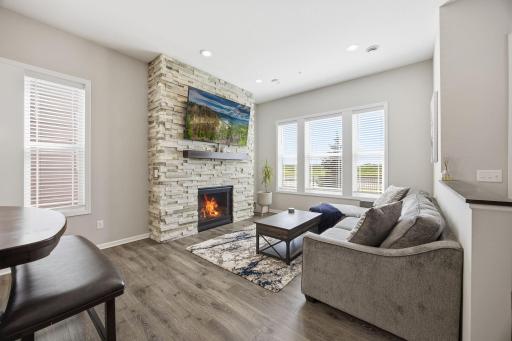 Bright living room with a gas fireplace, creating a warm and inviting main-level focal point