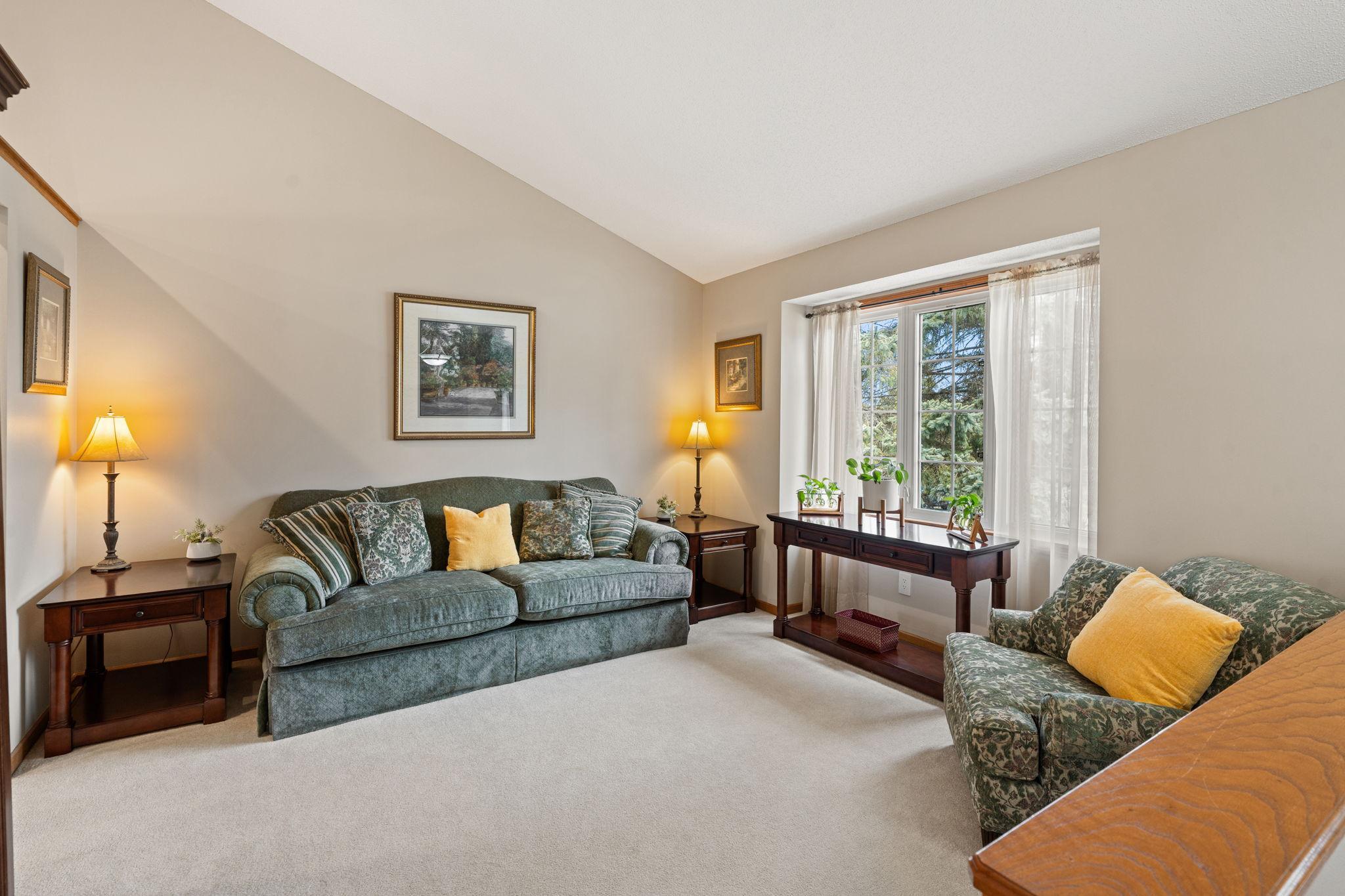 Formal family room off the front of the home with an abundance of natural light and vaulted ceilings.
