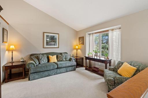 Formal family room off the front of the home with an abundance of natural light and vaulted ceilings.