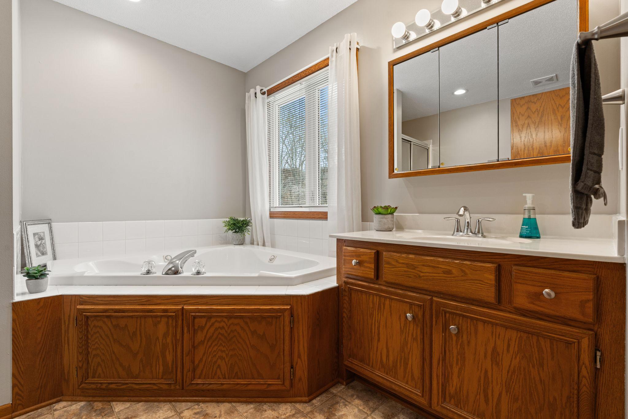 The primary bath offers a beautiful jetted tub...