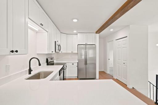 Kitchen area looking towards hallway towards upper level bedrooms