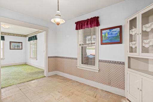 This dining room's built-in corner cupboard and rich architectural trim offer a genuine connection to the home's history creating an inviting space ready for memorable meals and gatherings.