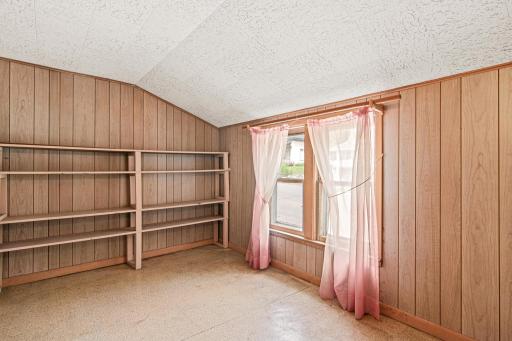 With a large window overlooking the neighborhood, this room offers a peaceful upstairs escape ready for your creative touch.
