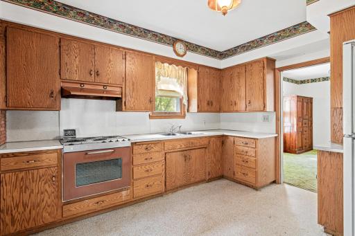 A window over the sink brings in natural light and backyard views, adding charm to this kitchen's potential for a fresh, personalized transformation.