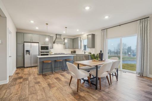 A stunning kitchen with ample counter space, including a 7-foot island provides the perfect setting for entertaining guests. Photo of model home, other finishes will vary.