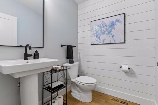 Main floor powder 1/2 bath with shiplap siding
