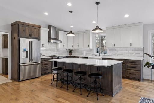 Spacious kitchen with tile backsplash and large island.