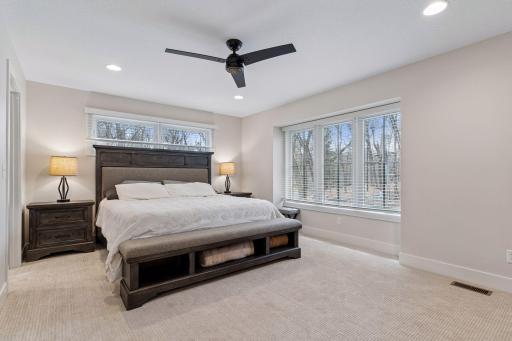 Spacious main floor primary bedroom with large closets and spacious bathroom suit