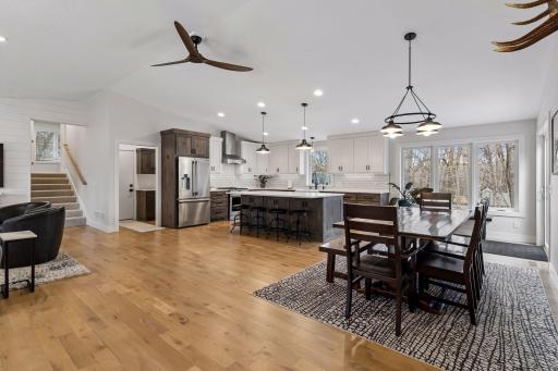 Open kitchen, dining and living room concept. Stairs lead to new addition and three bedrooms.