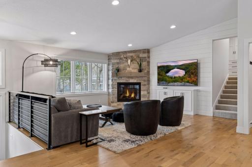Main level living room with stone gas fireplace