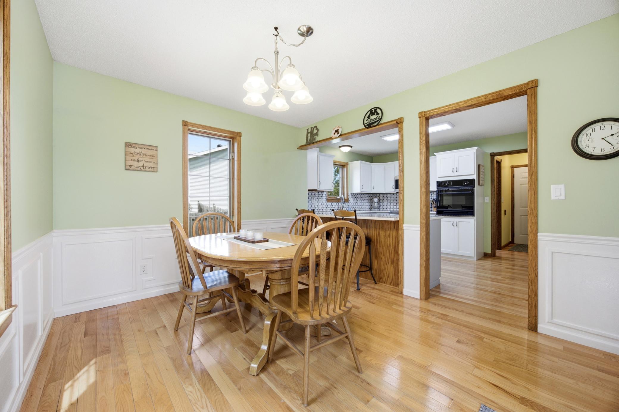 Dining open to Kitchen with Patio Access to Wraparound Deck and Backyard