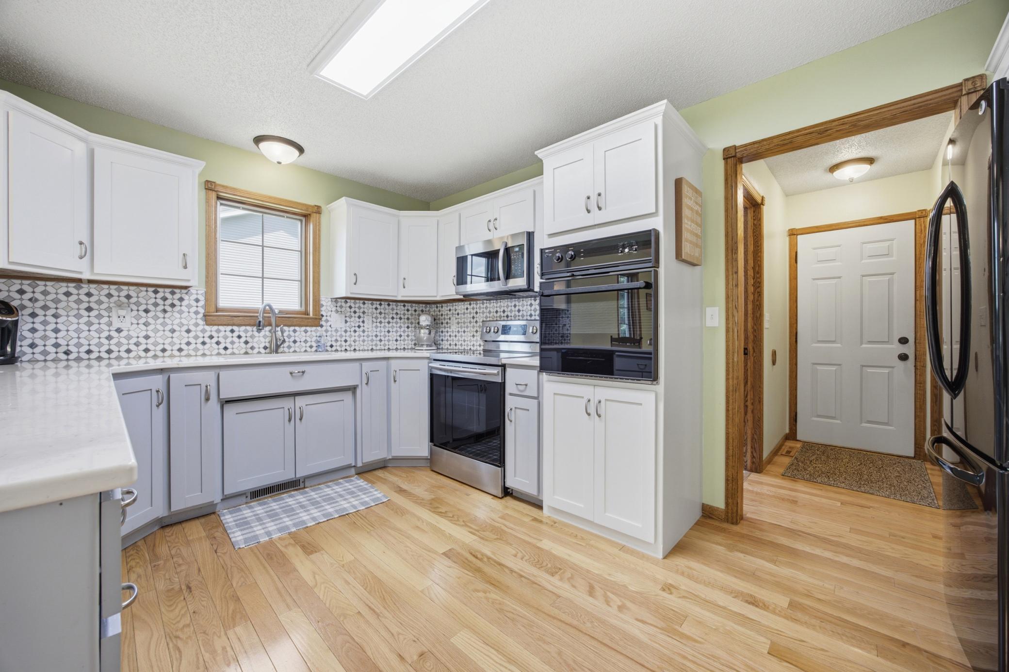Kitchen with Double Oven; Lots of Storage; Hardwood Floors; Direct access to Garage