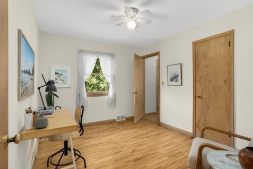 3rd bedroom on main level with doorway leading to back entry