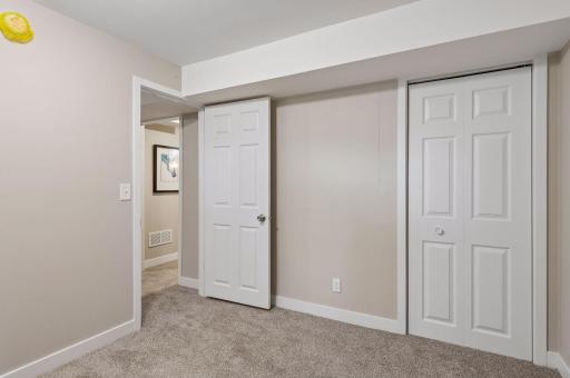 lowel level bedroom features new doors and spacious closet