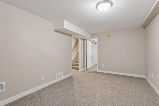 lower level family room facing adjacent bedroom