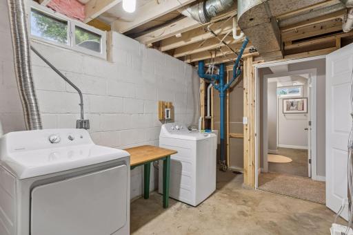 laundry area is clean and functional with newer washer and dryer