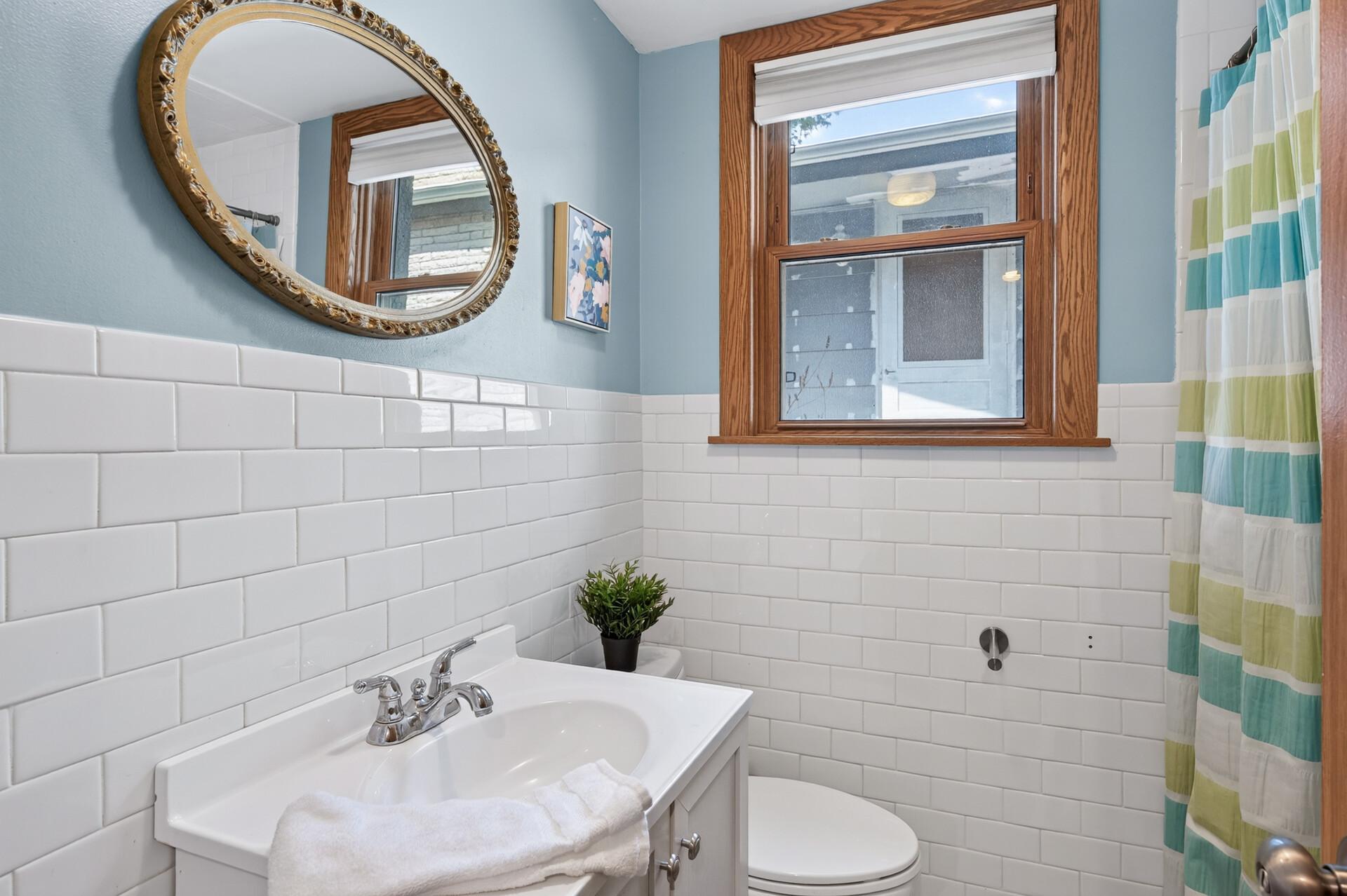The updated 3/4 bath showcases classic subway tile, modern fixtures, and a fresh, inviting feel.