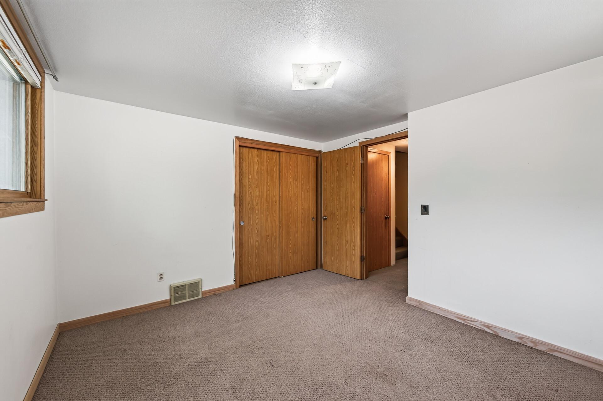 Spacious closets and comfortable finishes make this bedroom a relaxing retreat.