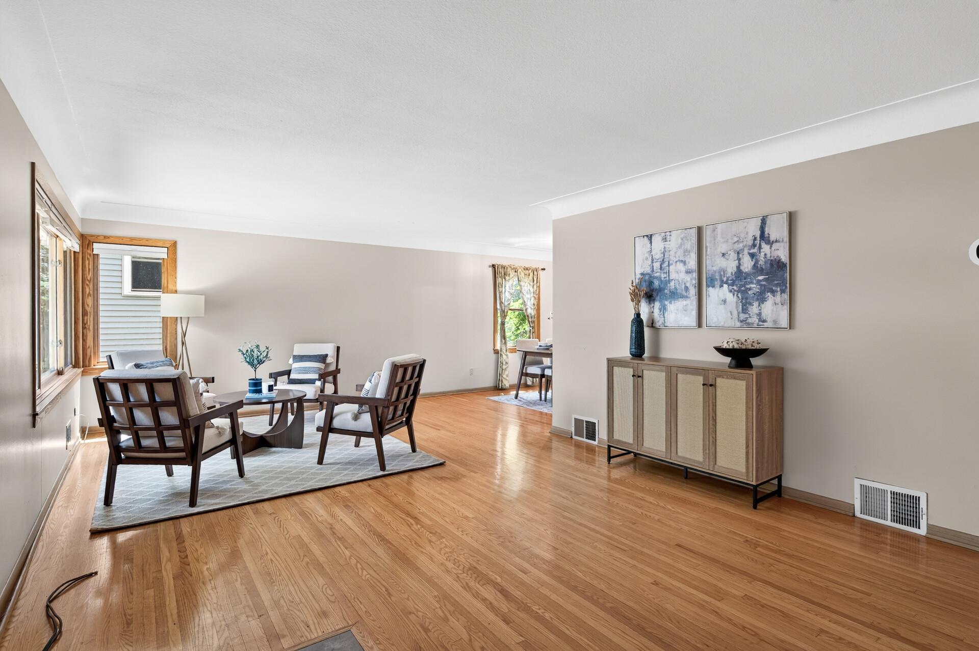 Hardwood floors flow throughout this spacious living and dining room filled with natural light.