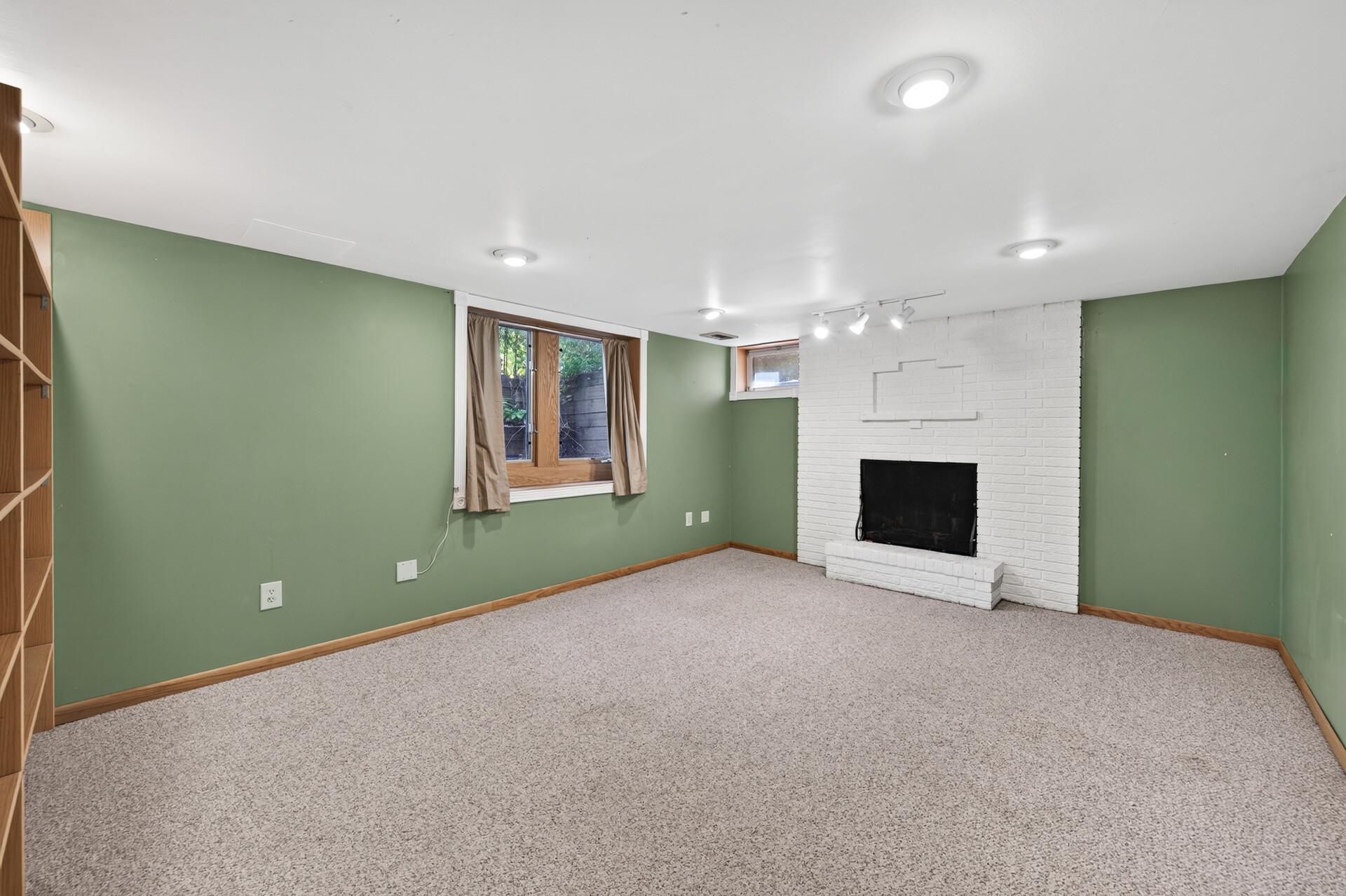 The expansive lower-level family room is perfect for movie nights, game days, or entertaining.