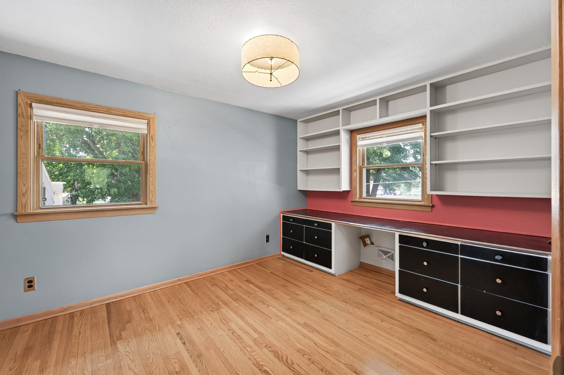 Built-in shelving and desk space create the perfect home office, study area, or creative workspace.