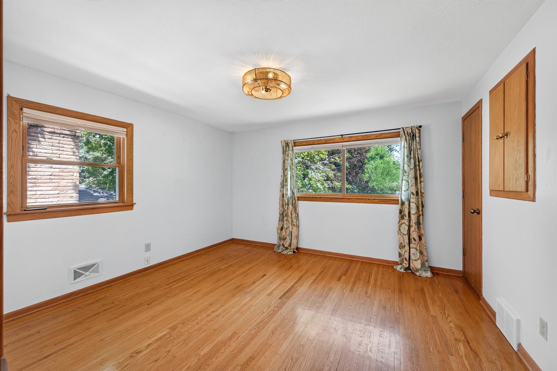 Wake up to peaceful backyard views from this bright and comfortable primary suite.