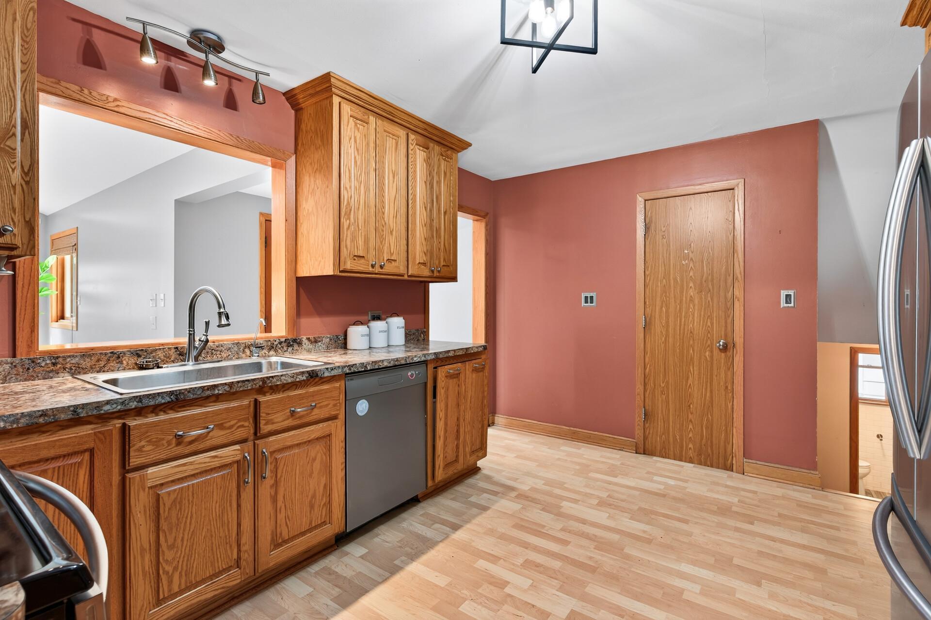 The kitchen offers generous storage, ample counter space, and easy access to the backyard deck.