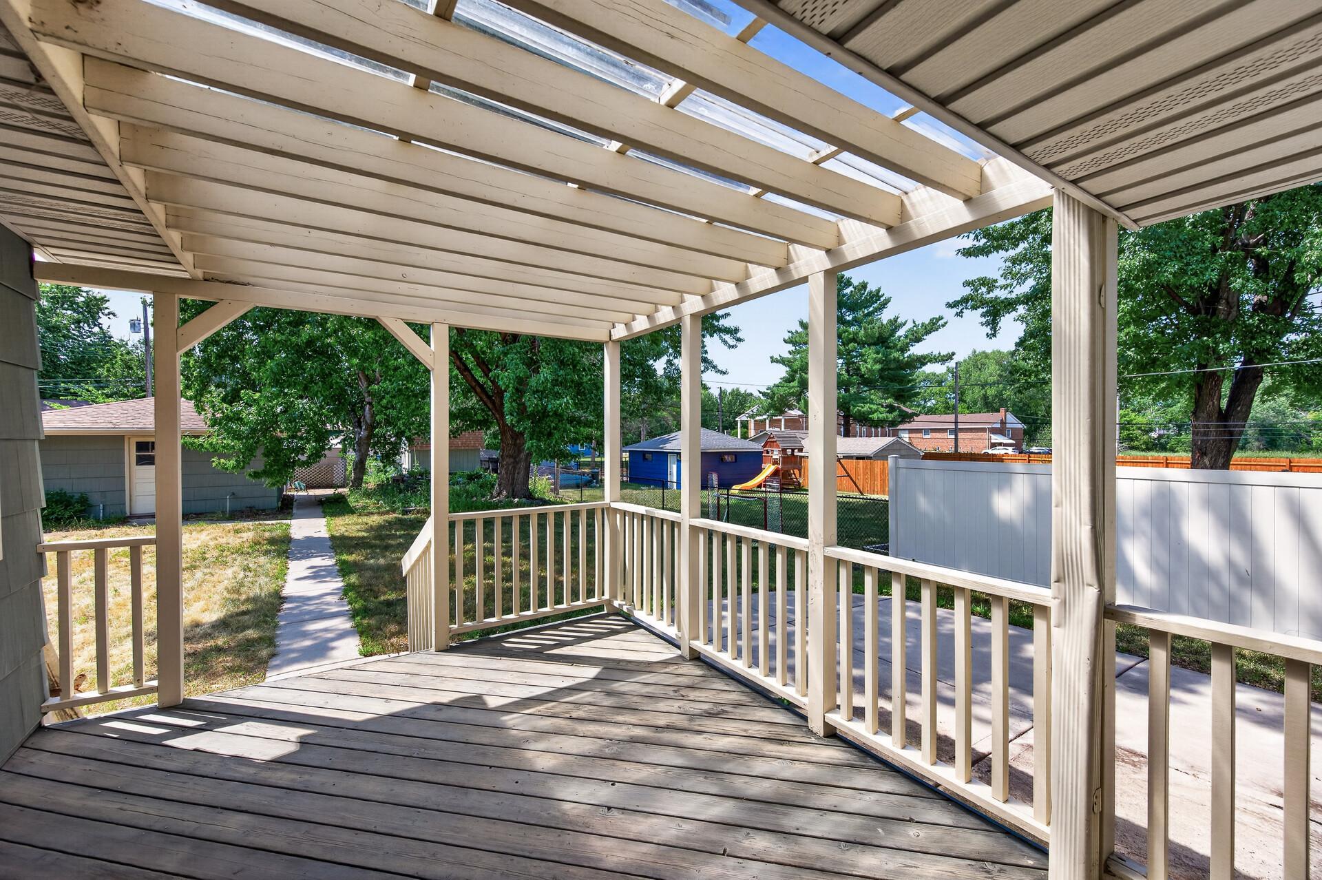 Enjoy summer evenings on the covered deck overlooking the private backyard.