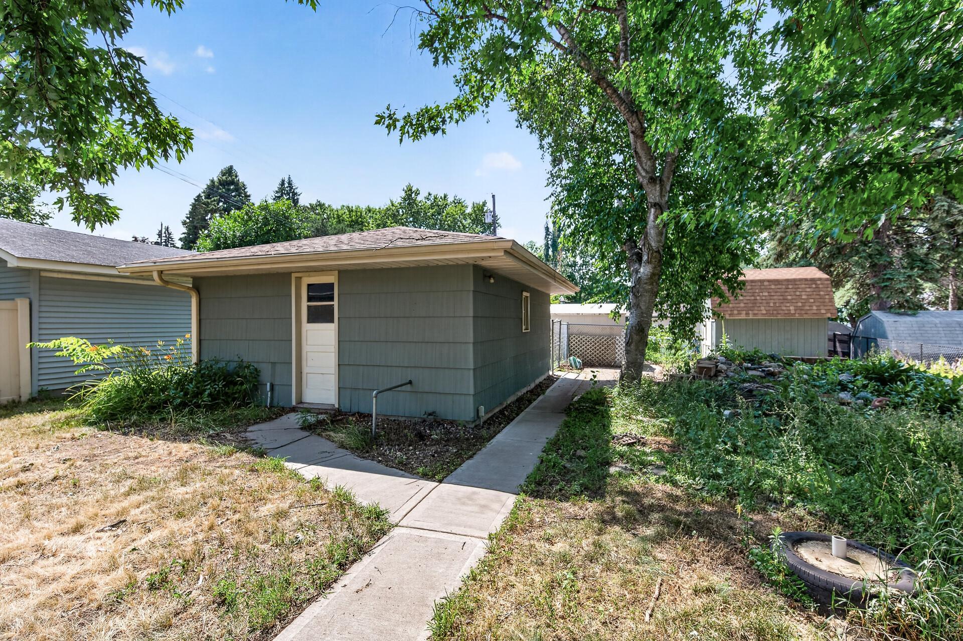 The detached garage offers additional storage and convenient backyard access.
