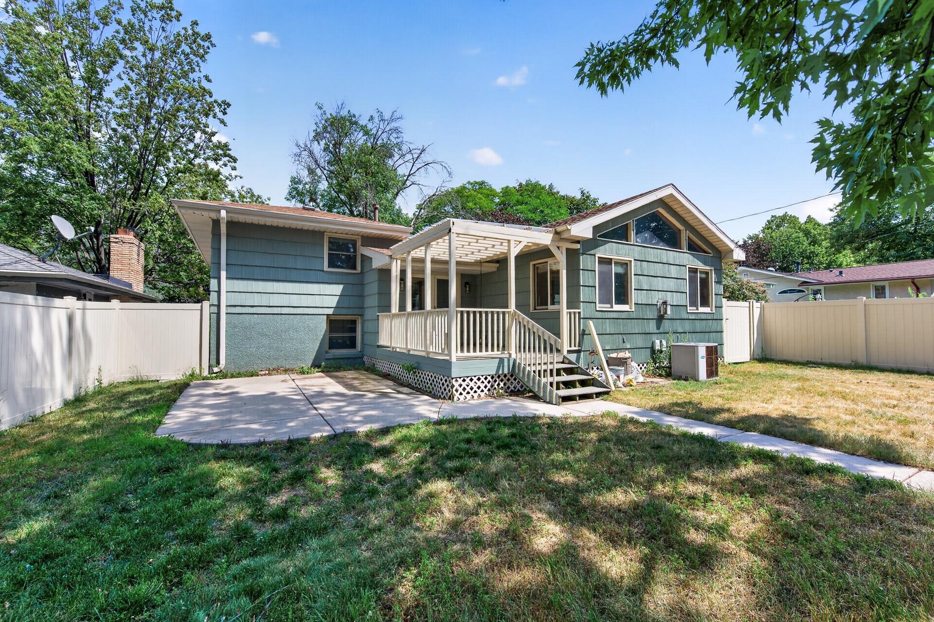 The backyard provides a wonderful blend of outdoor living space and mature shade trees.