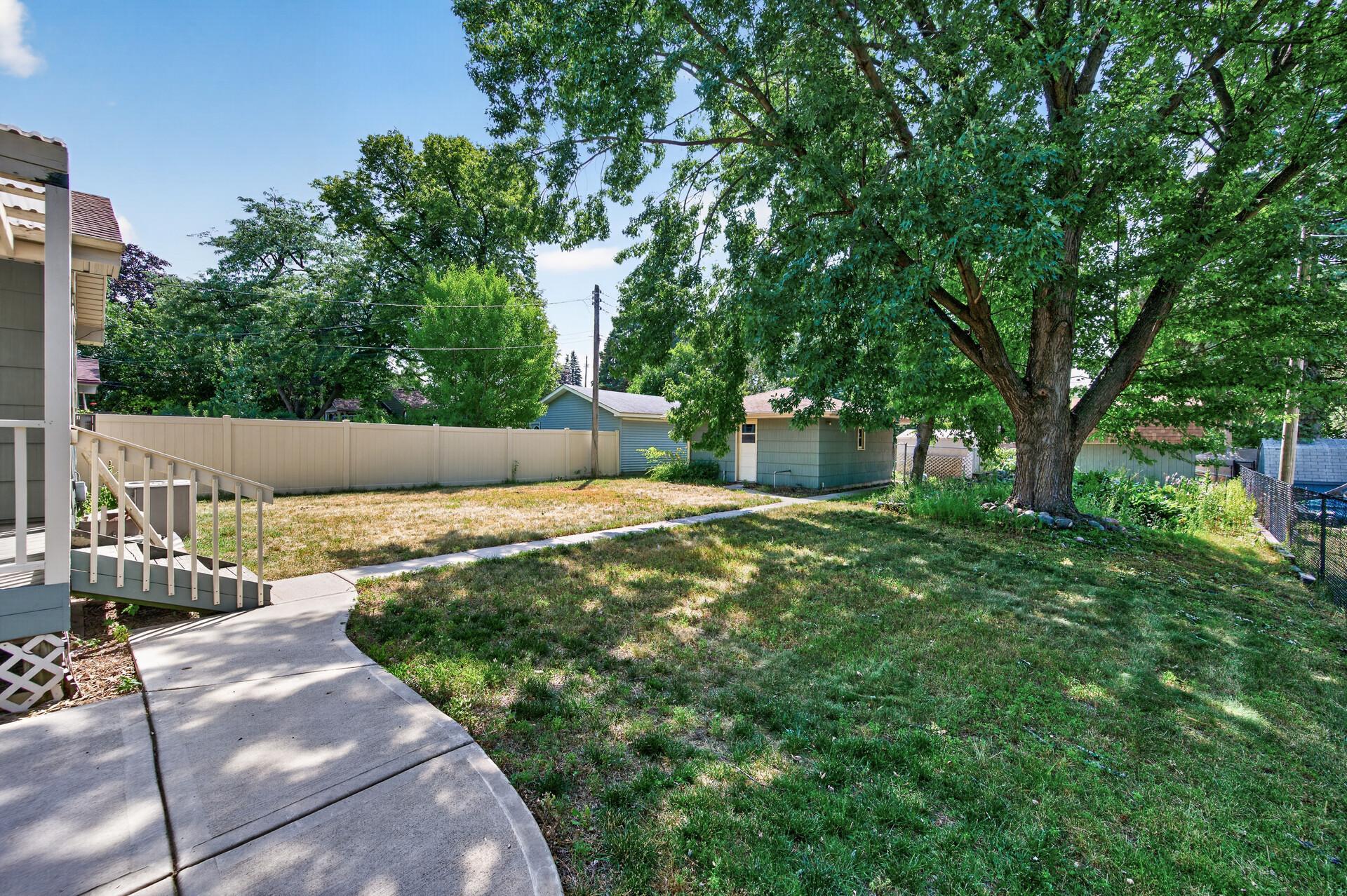 The fully fenced backyard offers plenty of room to relax, play, or entertain.