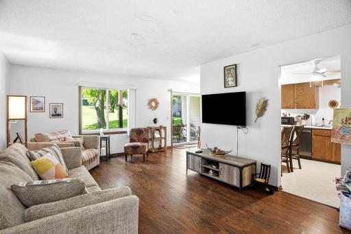 Spacious living room with wood flooring, large picture window, and abundant natural light.