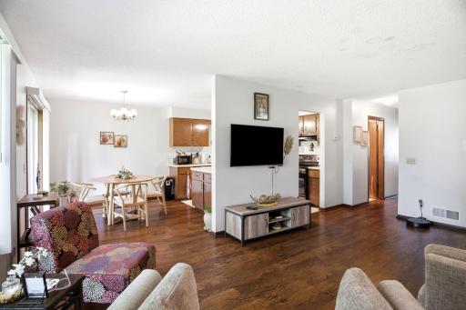 Open-concept living and dining areas with sliding glass door providing access to the patio.