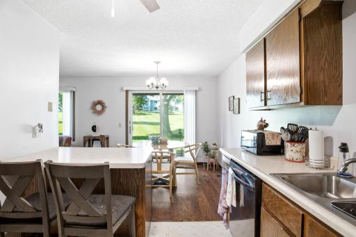 Additional kitchen perspective highlighting the island, work surfaces, and dining space.