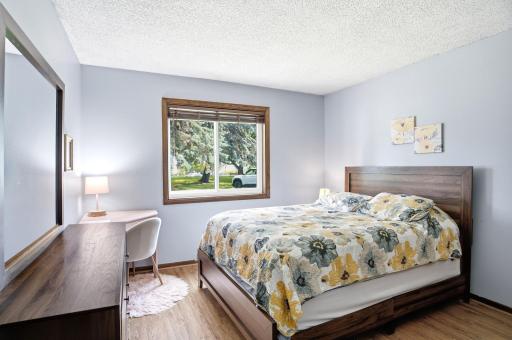 Alternate view of the primary bedroom with generous floor space and dressing area.