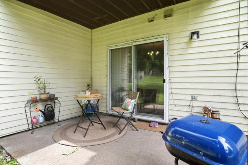 Private covered patio with room for outdoor seating and grilling, plus direct access to the common green space.