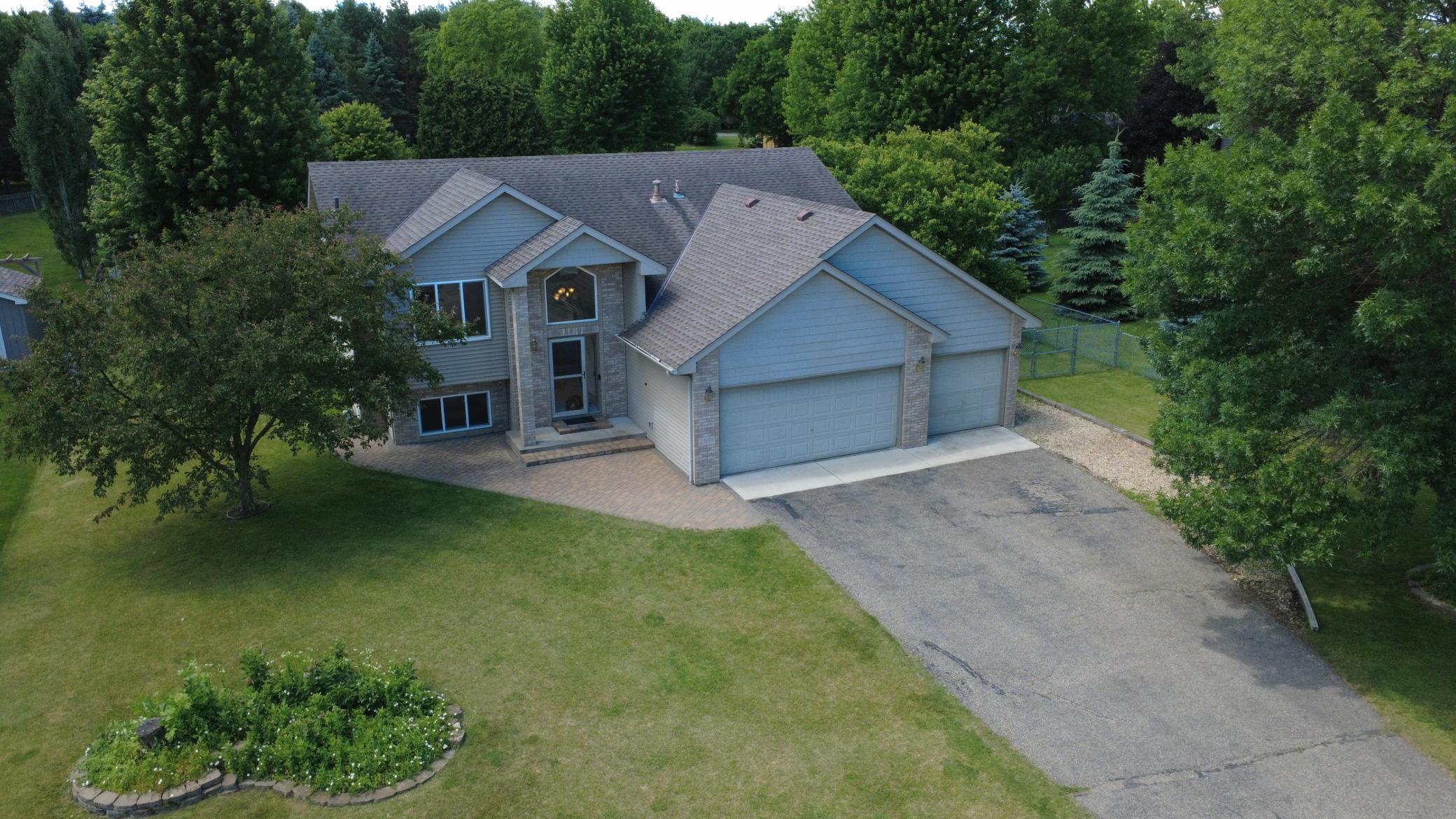 Aerial photo of front of home, noted newer driveway garage apron and parking space on side of garage for camper, boat or trailer.