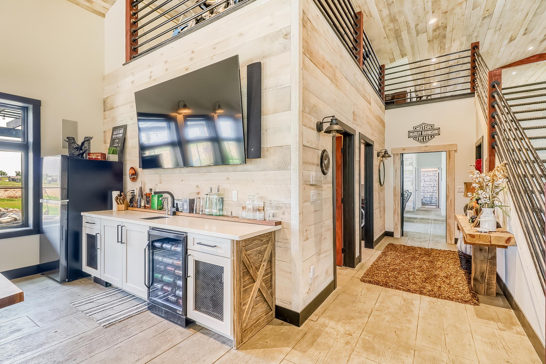 Shop Bar - 1/2 bath & laundry in hallway. View from bar to kitchen.